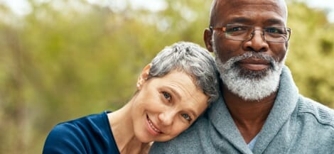 Man and woman smiling in the midst of a medical journey