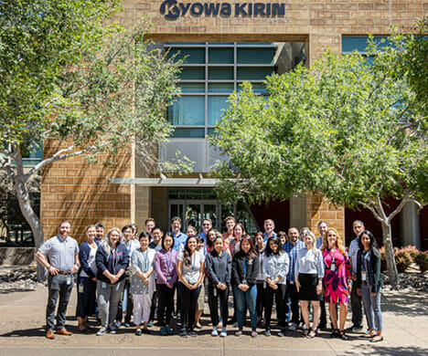 Group portrait of Kyowa Kirin North America employees in front of an office building